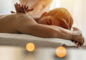 Sports massage. Massage therapist massaging shoulders of a male